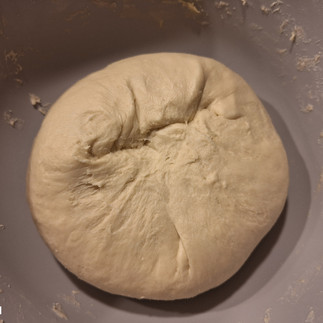 Cover the bowl and let the dough rise at room temperature for about 4 hours, until it looks puffy and has expanded noticeably.
