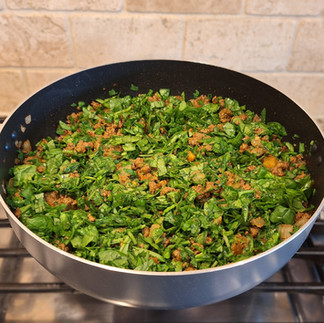 spinach beef tomato mix on skillet, mixed