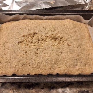 Brush risen bread with eggwash and apply sesame.