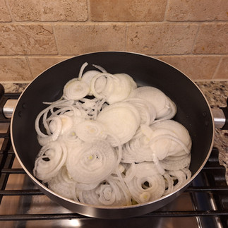 Heat butter or oil in a pan over low heat. Add the sliced onions and a pinch of salt. Cook slowly, stirring occasionally, until deeply golden and soft—about 25–30 minutes. Set aside.