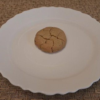 single cookie on white plate