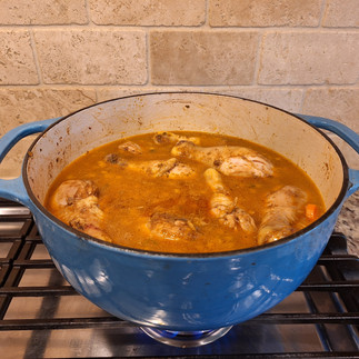 Nestle the seared chicken drumsticks on top of the rice