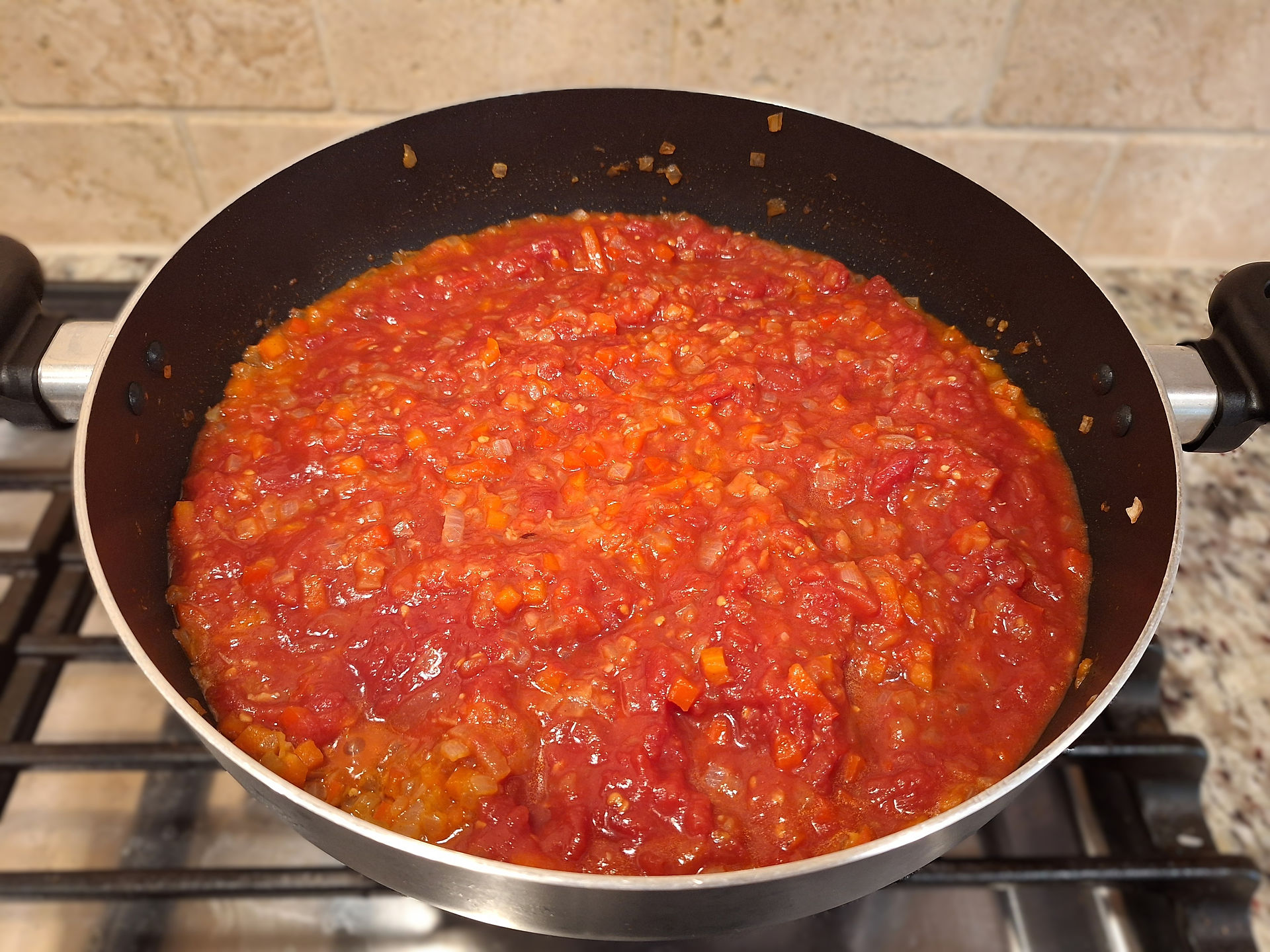 Pour in crushed tomatoes, season with salt and sugar. Simmer for 15–20 minutes until thick. Taste and adjust seasoning.