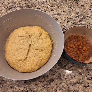 Roll out the chilled dough into a 12x16-inch rectangle on a floured surface. Spread the apple mixture evenly over the dough, leaving a ½-inch border. Roll tightly from the long edge to form a log. Slice the log into 6 equal pieces. Arrange the pieces in a greased loaf pan, cut side facing up, side by side.