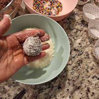 Shape into pingpong-sized balls using your hands (about 20 total). Roll each ball in desiccated coconut or sprinkles.