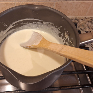 Gradually whisk in the heavy whipping cream, stirring constantly until the mixture thickens.