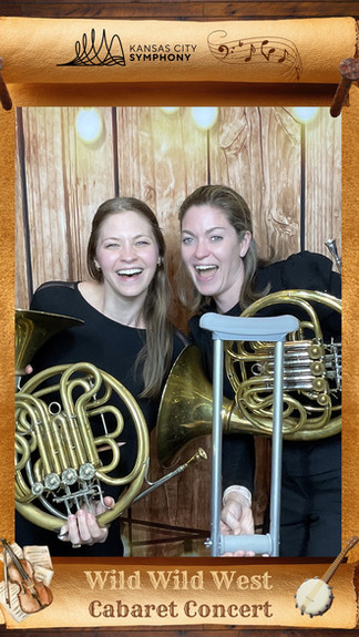 Two members of the KC Symphony pose for the Glam Cam KC photo booth with instruments