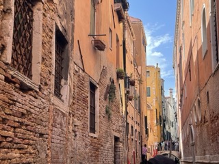 walls rising above Venetian canal