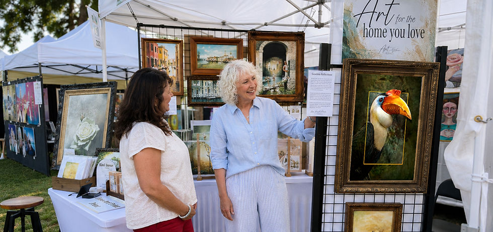 artist and woman discussing art piece