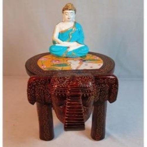 Artistic Buddha figurine on wooden elephant stand, elegant handcrafted home decor