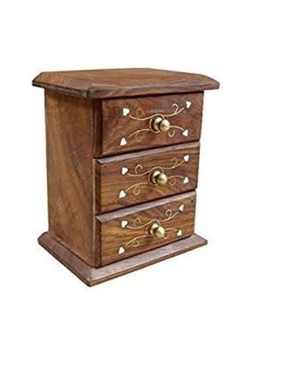 Angled view of 3-drawer wooden jewelry box with decorative carvings and brass knobs
