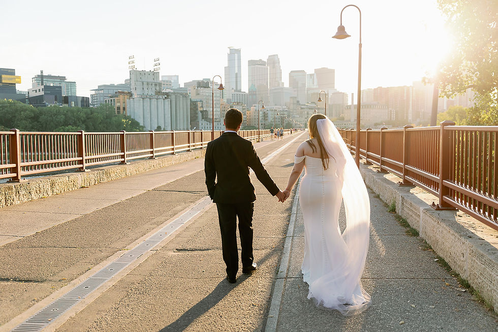 Newlyweds walking on Stone Arch Bridge for Twin Cities Event Planning