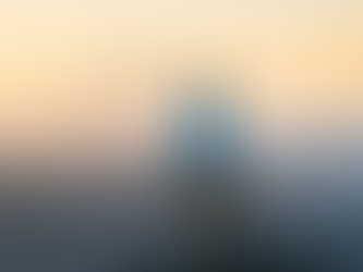 Man looking out over a valley at sunrise looking for inspiration