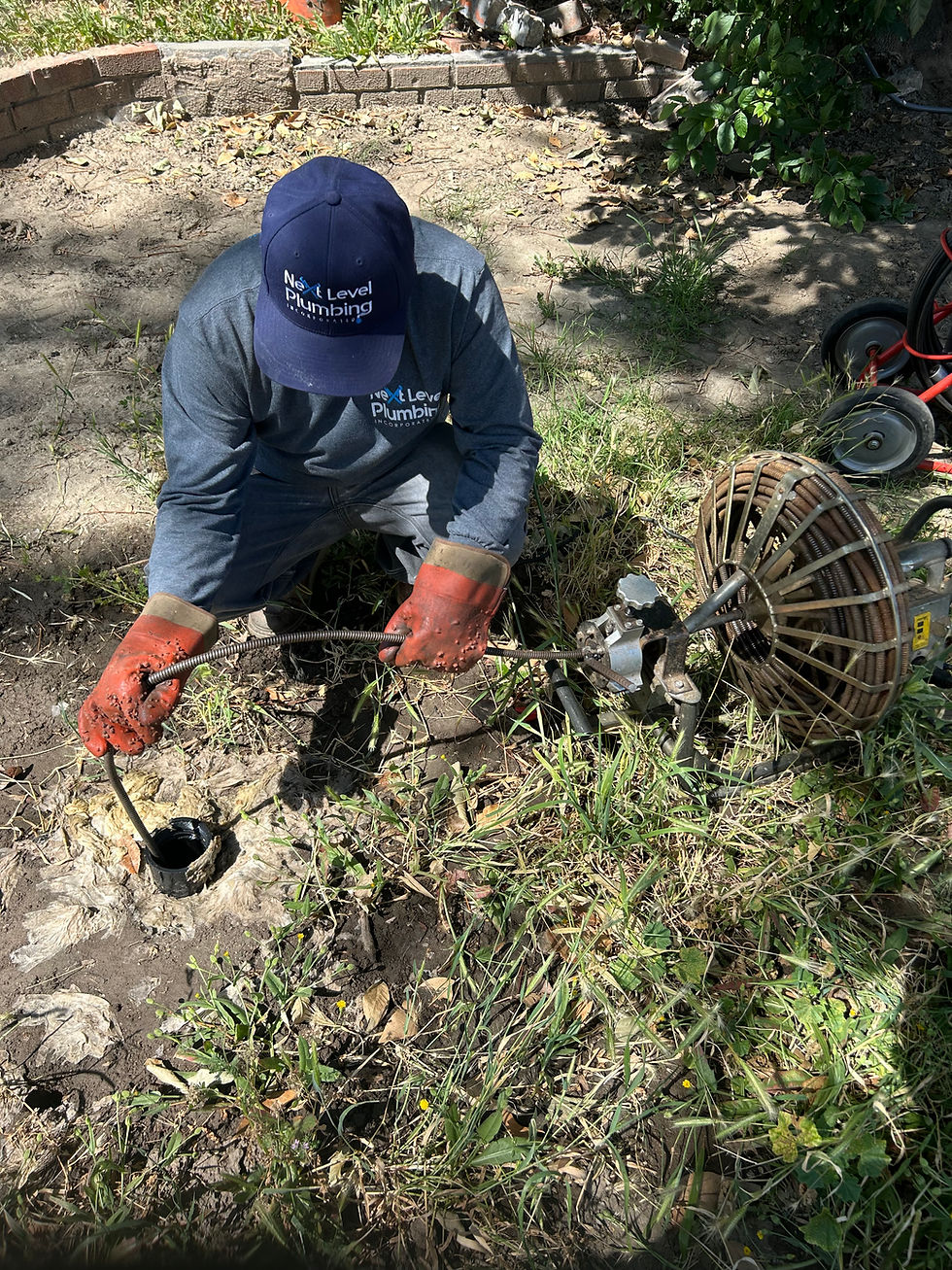 Plumber in branded clothing working outdoors on a plumbing job