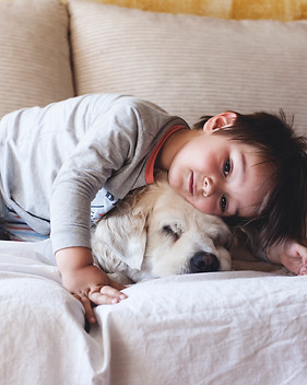 Boy Cuddling with his Dog