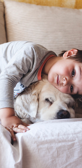 Boy Cuddling with his Dog