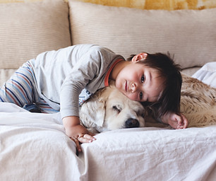 Boy Cuddling with his Dog