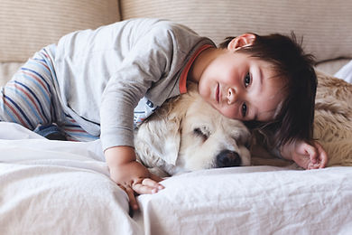 Boy Cuddling with his Dog