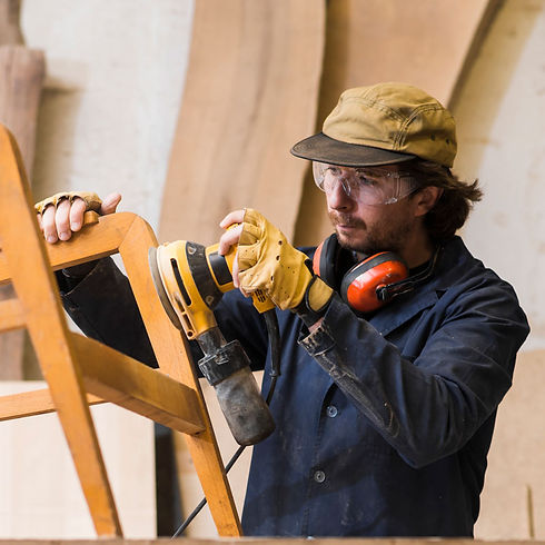 male-carpenter-sanding-wood-with-orbital-sander-workshop.jpg
