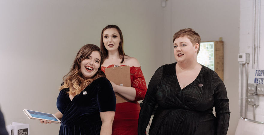 gallery filled with people standing and looking at art