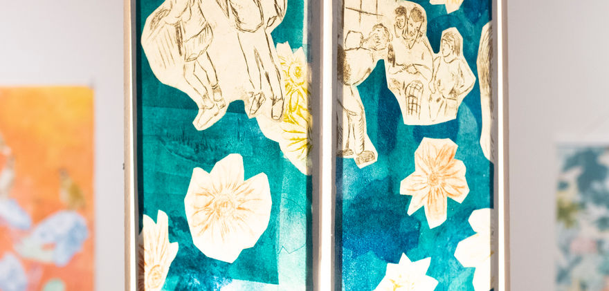 Close up of the lantern above the mahjong table. Large cylindrical lantern with floral patterns and background colors in red and green.