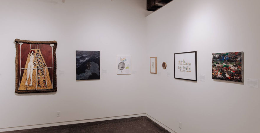 gallery wall with paintings displayed on wall