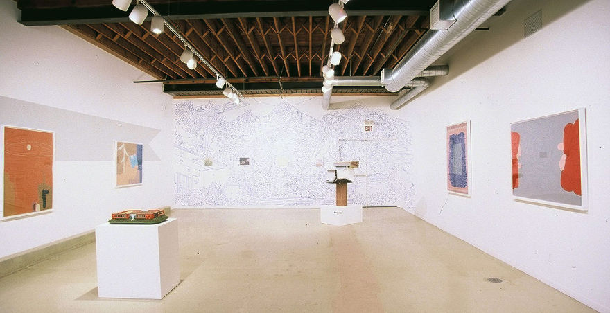 large gallery with many sculptural works and abstract paintings