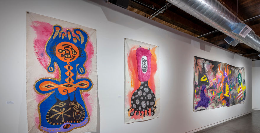 three large un stretched canvass with abstract colorful art 