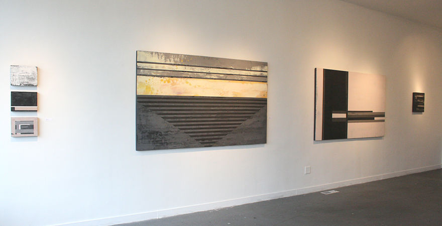 large abstract painting with stripes of dark grey and tan