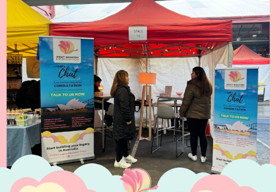 Legacy Migration representatives assisting visitors at their Grand Fiesta booth