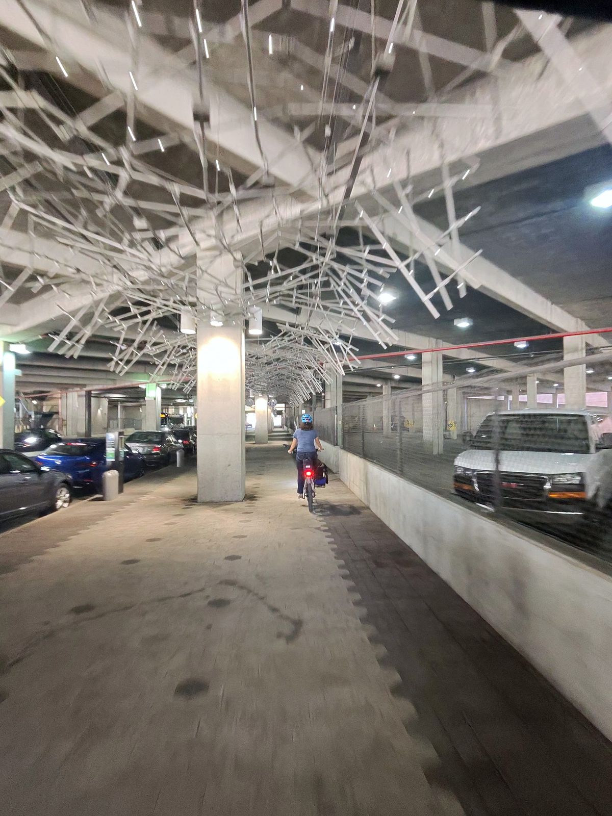 Riding beneath the overhead structure along a covered city passage.