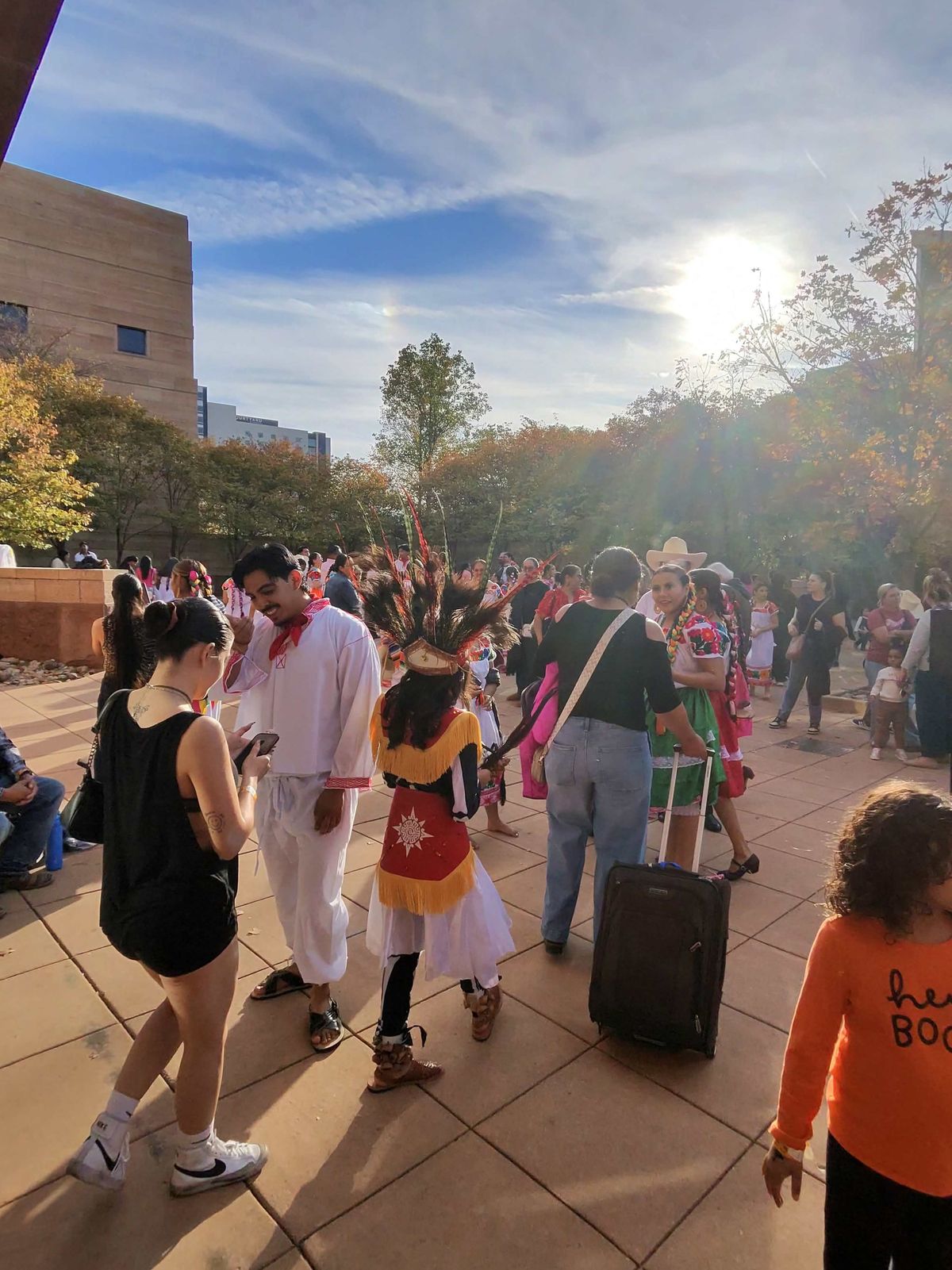 Colorful outfits and feathered headdresses at the Day of the Dead celebration outside the Eiteljorg Museum.