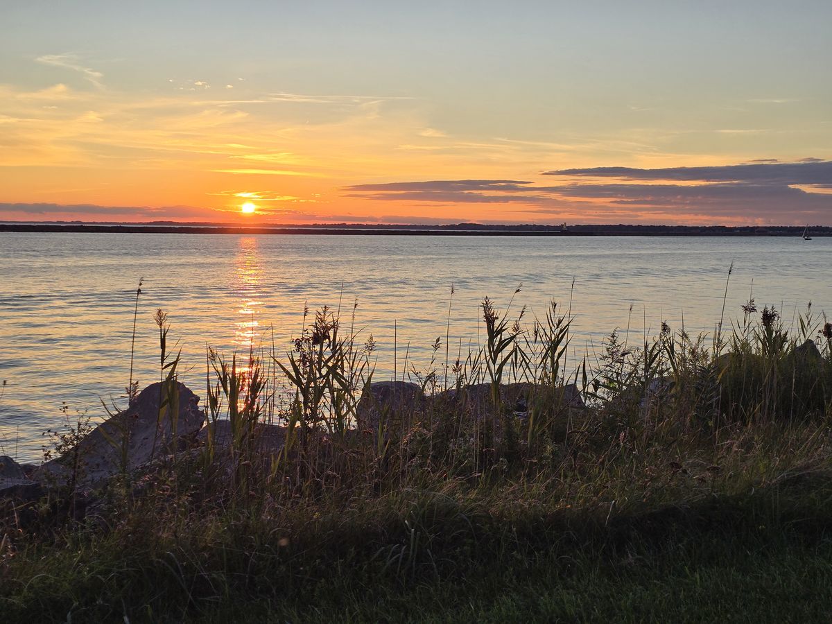 A quiet sunset stop along the water before we kept riding.
