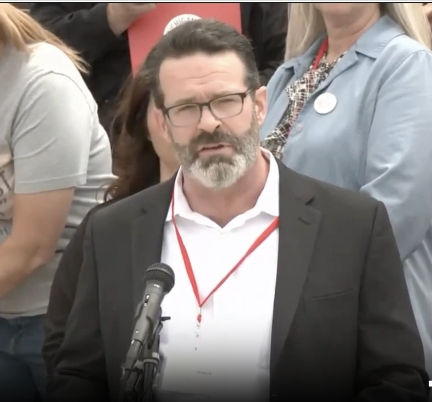 Dr Nevin speaking at Lansing press conference