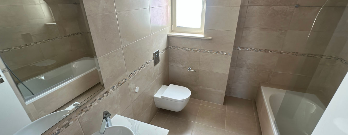 Modern bathroom with wall-mounted toilet and basin