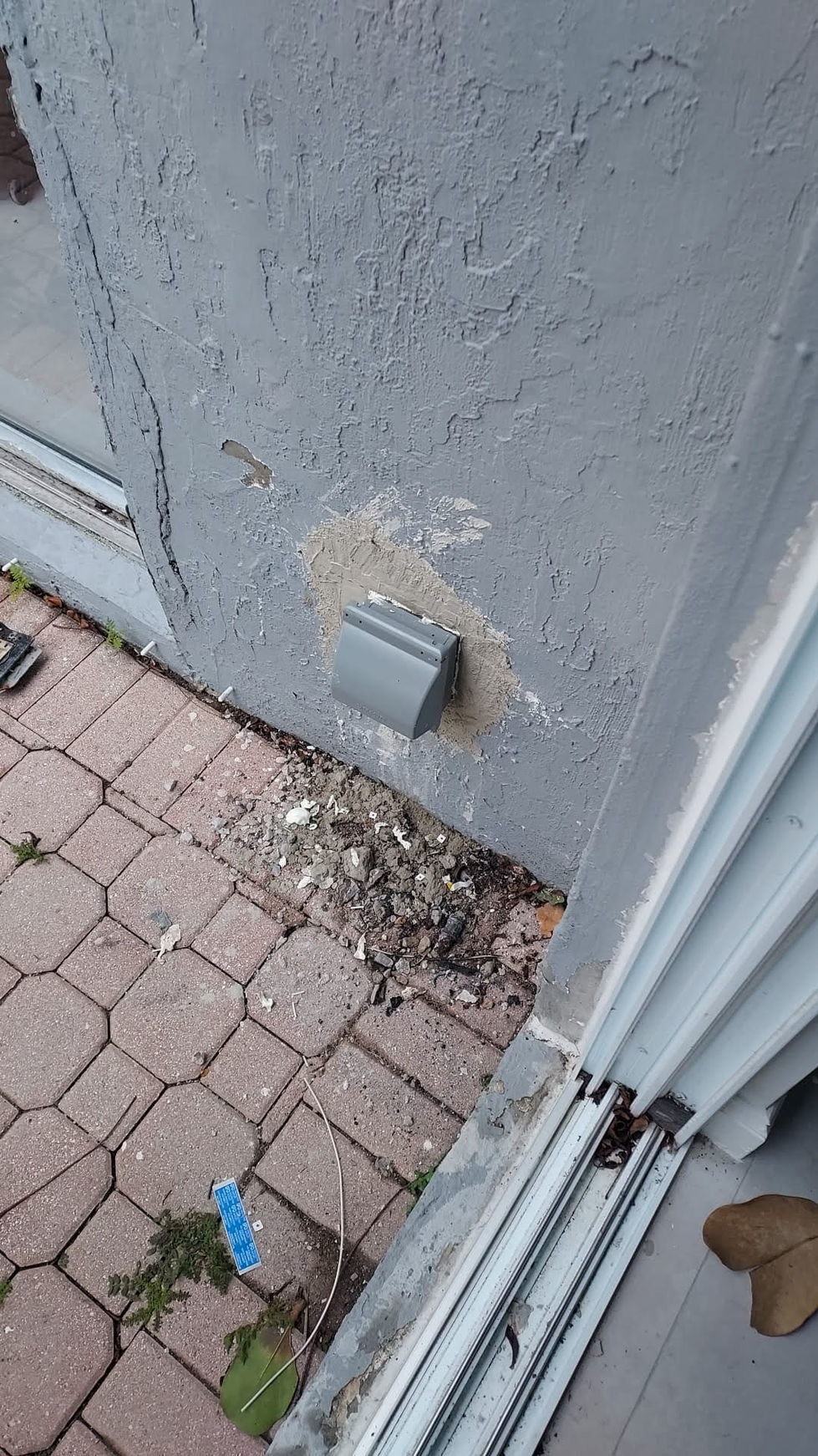 a gray electrical outlet on the side of a building