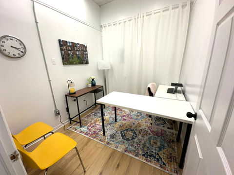 a small white office with a white desk