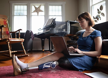 Woman with Amputee Using Laptop