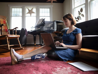 Woman with Amputee Using Laptop