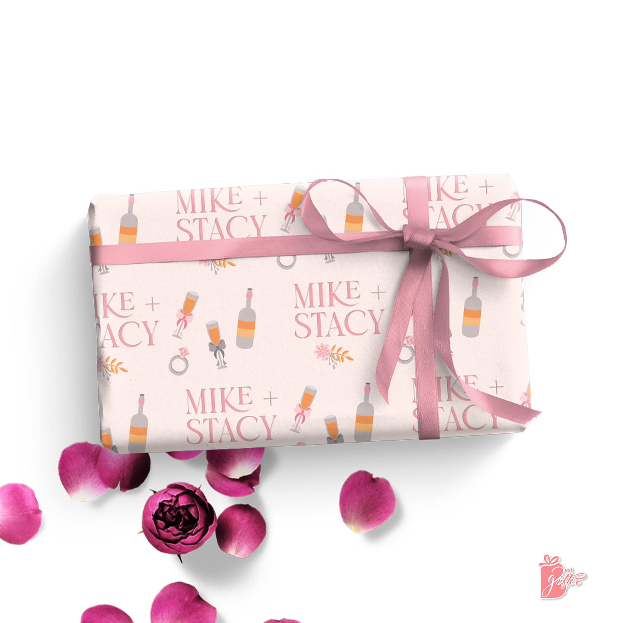 Champagne glass toasts on pastel pink gift wrap with personalized couple's names