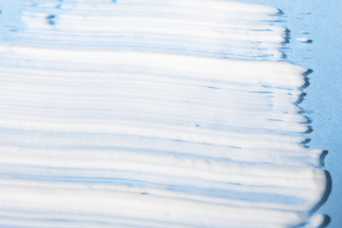 white-cosmetic-product-blue-background-closeup-body-face-cream-min.jpg