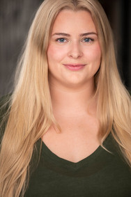 actor headshot blond woman average build smirk