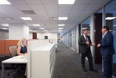 office action shot hallway and desk with professionals