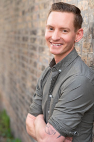 actor headshot young white man outdoor on brick wall