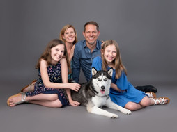 happy family with dog studio portrait
