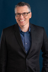 app developer professional headshot portrait on blue background