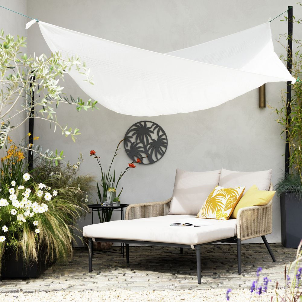 natural rattan effect garden day bed with cream cushions