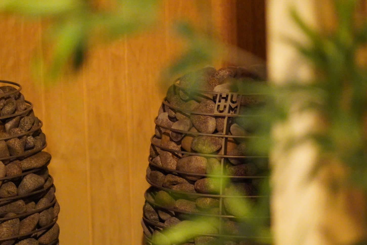 Close-up of huum stove heater inside wooden sauna setting
