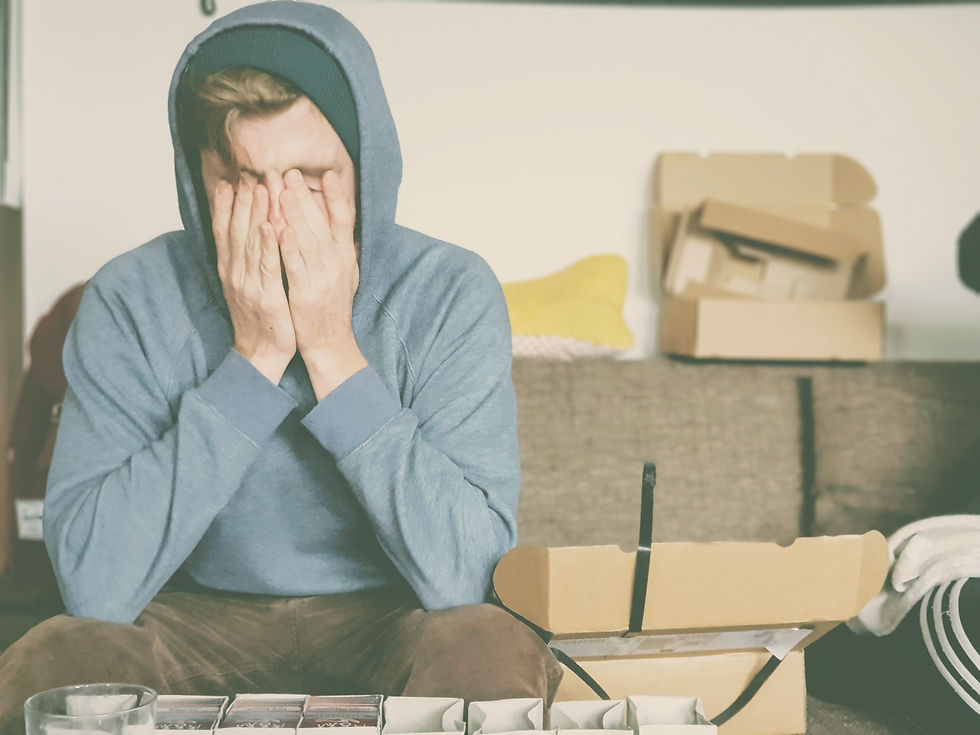 A man sitting disappointed in a rented property in Germany