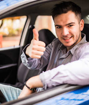 happy-smiling-man-sitting-inside-car-showing-thumbs-up-handsome-guy-excited-about-his-new-